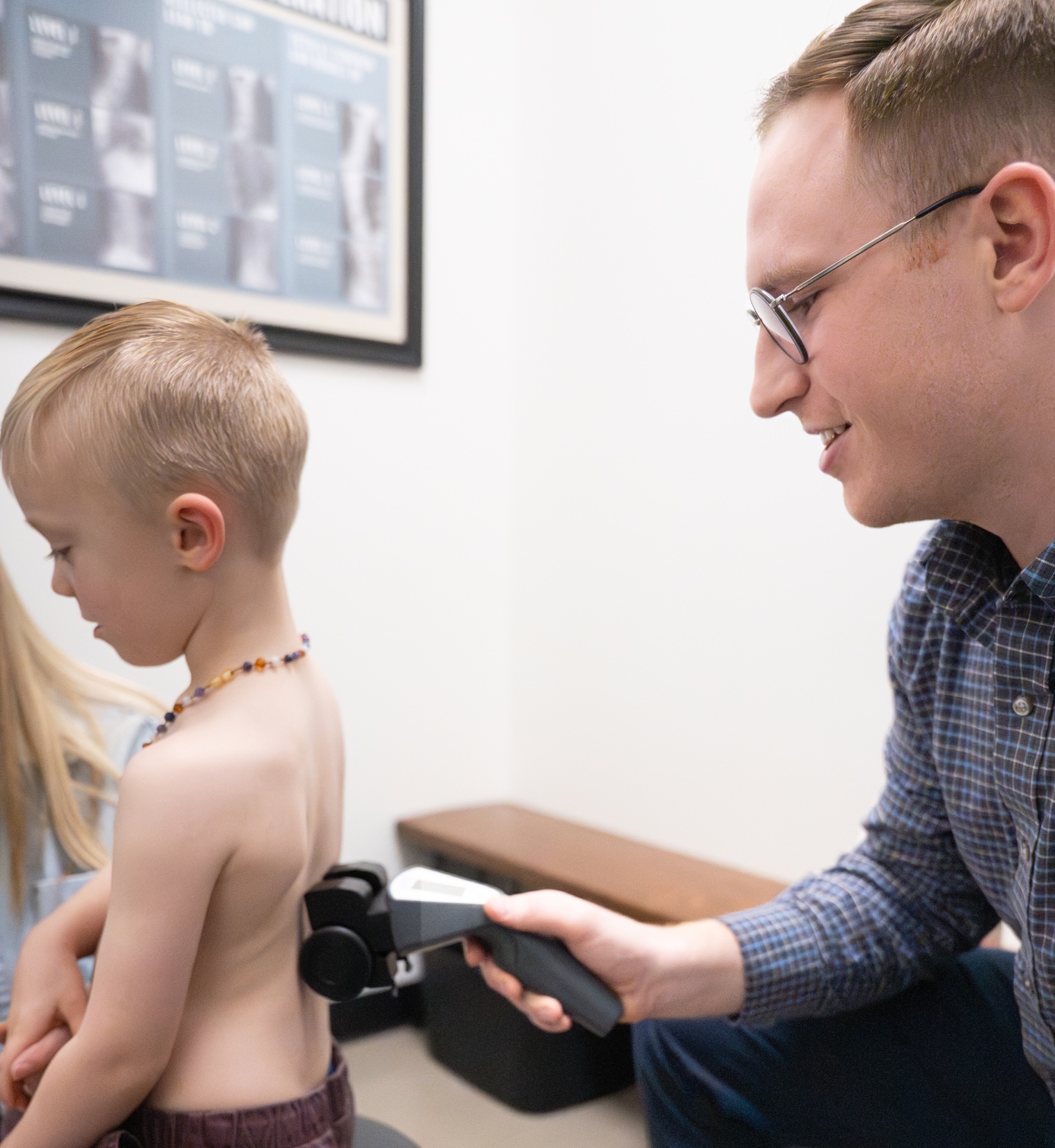 Dr. Blake performing a CLA Insight nervous system scan on a young child